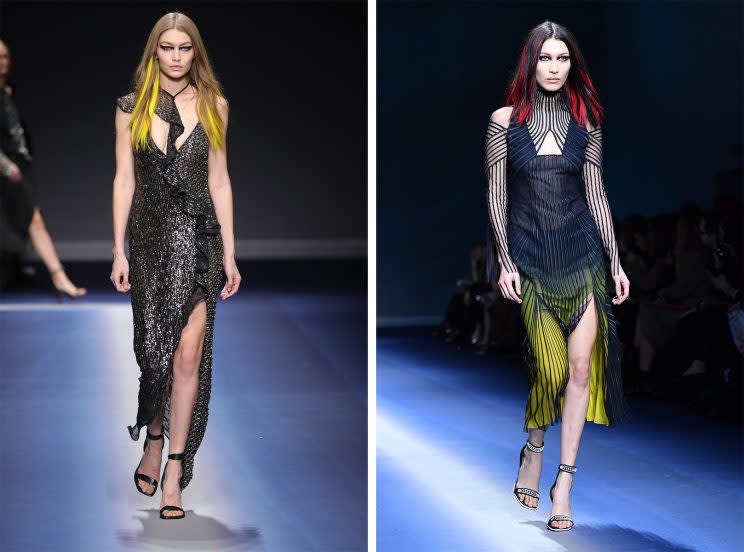 Sister supermodels Gigi and Bella Hadid walk in Versace’s Fall 2017 runway show in Milan with Manic Panic-style streaks in their hair. (Photo: Courtesy of Getty Images)