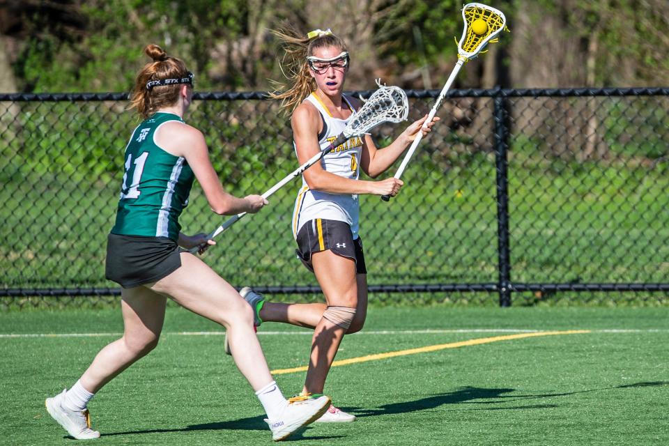 Tatnall School senior Lydia Colasante (4) defends control of the ball against Tower Hill High School junior Anna Schlobach (11) during the girls lacrosse game at the Tatnall turf field in Greenville, Thursday, April 13, 2023. Tatnall won 23-8.