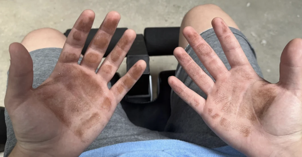 A person's hands, palms up, are shown covered in dirt