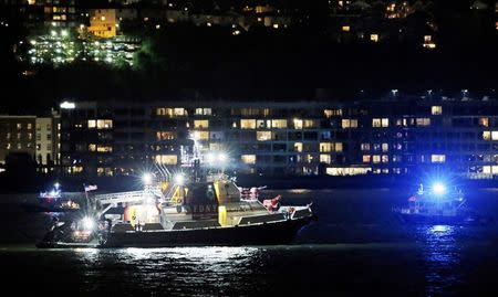 An FDNY fire department boat searches the Hudson River for the wreckage of a vintage P-47 Thunderbolt airplane that crashed in the river in New York City, New York, U.S. May 27, 2016. REUTERS/Brendan McDermid