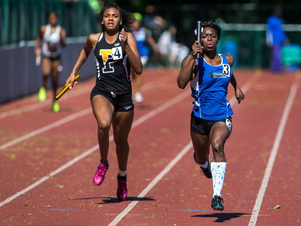 Middletown's Daija Lampkin anchors her school's 4x200 meter relay team to a win as she races past Padua's Taliah Cintron in the New Castle County Track and Field Championships at Baynard Stadium in 2017.