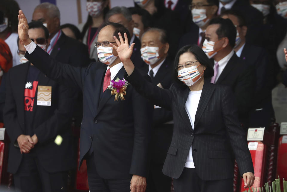 Taiwan's President Tsai Ing-wen, right, and Yu Shyi-kun, speaker of the Legislative Yuan, cheer with audience during National Day celebrations in front of the Presidential Building in Taipei, Taiwan, Saturday, Oct. 10, 2020. President Tsai said Saturday she has hopes for less tensions with China and in the region if Beijing will listen to Taipei’s concerns, alter its approach and restart dialogue with the self-ruled island democracy.(AP Photo/Chiang Ying-ying)