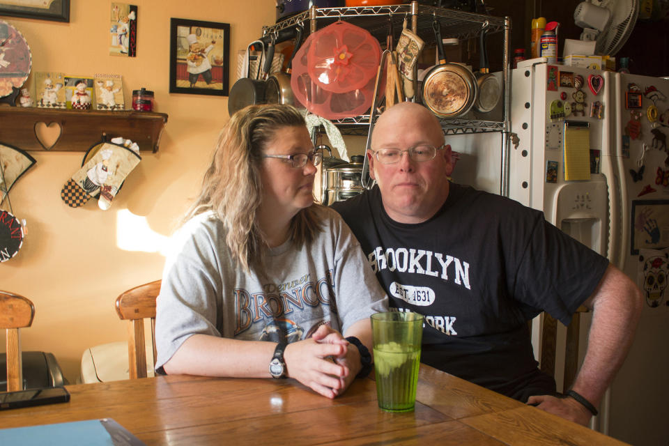 FILE - In this Friday, July 7, 2017 photo, Tammie Jackson, and her husband, Travis, discuss their Medicaid program benefits at their home in Helena, Mont. Tammie, who was uninsured until she enrolled in Montana's expanded Medicaid program, receives medical care for a host of health issues, including a back injury that has kept from returning to her job cleaning hotel rooms. In 2018, Montana seeks to raise a tobacco tax to keep funding a Medicaid expansion that is set to expire. (AP Photo/Bobby Caina Calvan)