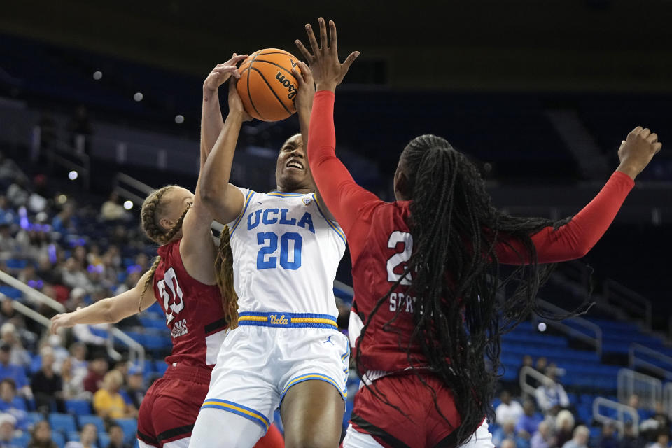 UCLA guard Charisma Osborne, center, shoots as Cal State Northridge guard Erica Adams, left, and forward Kayanna Spriggs defend during the first half of an NCAA college basketball game Thursday, Dec. 7, 2023, in Los Angeles. (AP Photo/Mark J. Terrill)