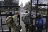 With the U.S. Capitol in the background, troops are let through a security gate on Saturday, Jan. 16, 2021, in Washington as security is increased ahead of the inauguration of President-elect Joe Biden and Vice President-elect Kamala Harris. (AP Photo/John Minchillo)