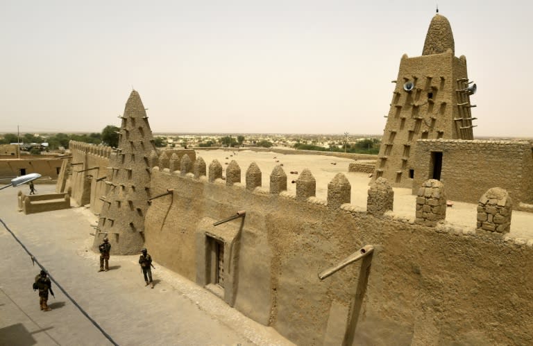 French and Malian Armed Forces soldiers patrol next to the Djingareyber Mosque on June 6, 2015 in Timbuktu