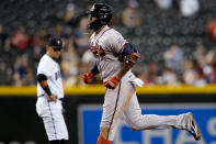 Atlanta Braves' Jorge Soler rounds the bases after hitting a solo home run as Arizona Diamondbacks' Ildemaro Vargas looks on during the fifth inning of a baseball game, Tuesday, Sept. 21, 2021, in Phoenix. (AP Photo/Matt York)