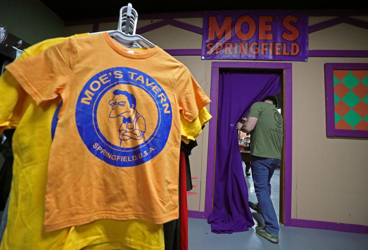 A Missing Falls Brewery worker enters Moe's, a pop-up experience designed to look like Moe's Tavern from The Simpsons, inside the brewery, on Friday in Akron. Fans of the longest-running animated series can purchase tickets to the pop-up until Jan. 28.