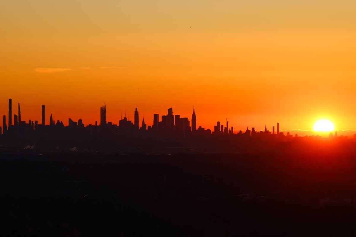 The sun rises over midtown Manhattan in a view from West Orange, New Jersey (AFP via Getty Images)