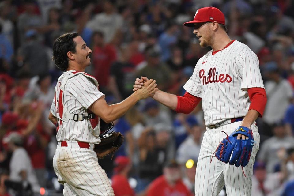 Philadelphia Phillies catcher Garrett Stubbs and pitcher Jeff Hoffman celebrate a win against the Los Angeles Dodgers at Citizens Bank Park in Philadelphia on Wednesday, July 10, 2024.