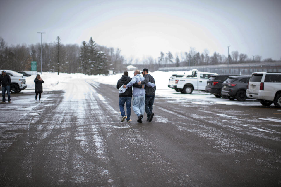 Thomas Rhodes, center, walks out of the Minnesota Correction Facility in Moose Lake, Minn., on Friday, Jan. 13, 2023, after authorities vacated his murder conviction in the 1996 death of his wife. Rhodes served 25 years in prison for murder, but authorities said Friday that his conviction would be vacated due to flawed testimony from an expert witness. Rhodes instead pleaded guilty to manslaughter on Friday and got credit for time served. (Fong Lee via AP)