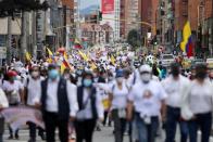 People march against road blockades in Bogota