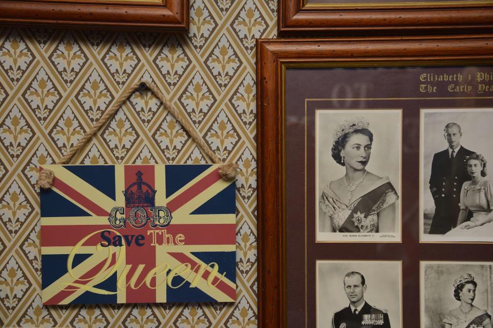 Photographs and a royal declaration are seen at the house of Margaret Tyler in west London