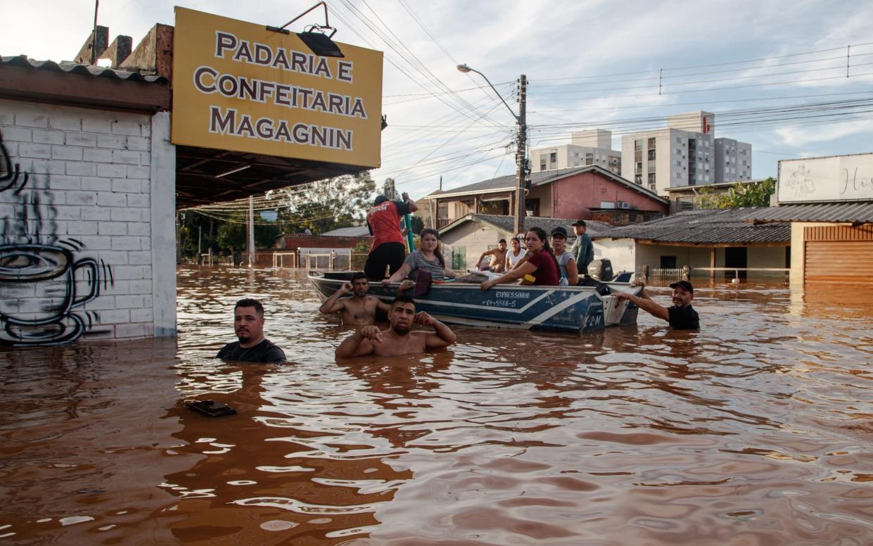 People pictured rowing through floodwater