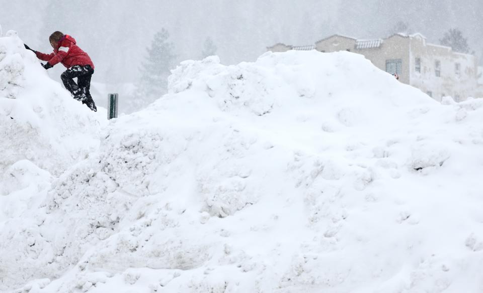 TRUCKEE, CALIFORNIA - MARCH 02: A child plays on a snowbank as snow falls north of Lake Tahoe during a powerful multiple day winter storm in the Sierra Nevada mountains on March 02, 2024 in Truckee, California. Blizzard warnings were issued with snowfall of up to 12 feet and wind gusts over 100 mph expected in some higher elevation locations. Yosemite National Park is closed and a 50-mile stretch of Interstate 80 was shut down yesterday due to the storm. (Photo by Mario Tama/Getty Images) ORG XMIT: 776114505 ORIG FILE ID: 2053533942