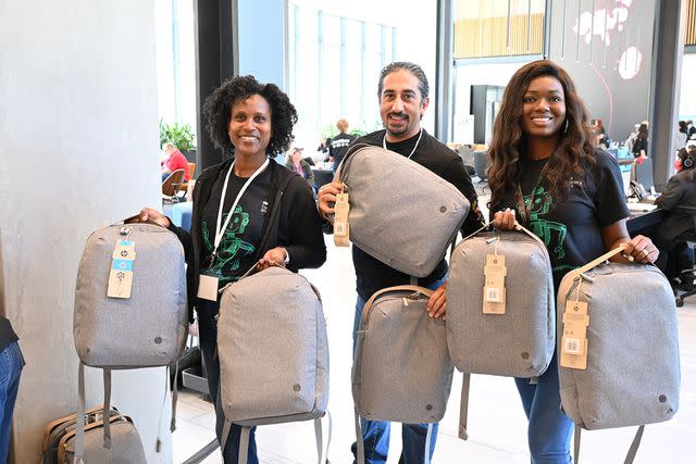 <p>Hewlett Packard Enterprise Company</p> Hewlett Packard Enterprise staffers distribute backpacks with school supplies at the 2023 CodeWars programming competition in Houston.