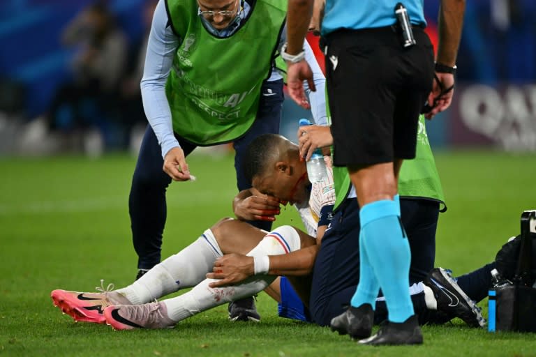 Kylian Mbappe receives medical treatment after breaking his nose during France's 1-0 win against Austria at Euro 2024 (OZAN KOSE)