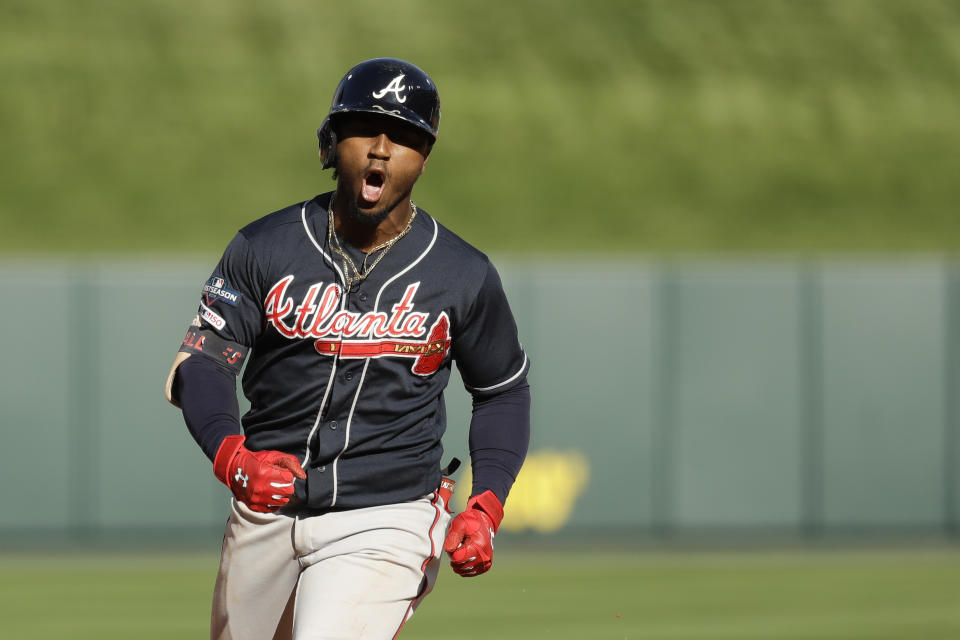 Atlanta Braves' Ozzie Albies celebrates after hitting a two-run home run during the fifth inning in Game 4 of a baseball National League Division Series against the St. Louis Cardinals, Monday, Oct. 7, 2019, in St. Louis. (AP Photo, Charlie Riedel)