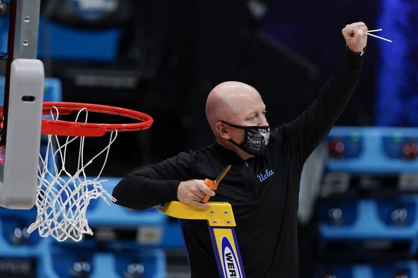 UCLA head coach Mick Cronin cuts down the net after an Elite 8 game against Michigan in the NCAA men's college basketball tournament at Lucas Oil Stadium, Wednesday, March 31, 2021, in Indianapolis. UCLA won 51-49. (AP Photo/Michael Conroy)