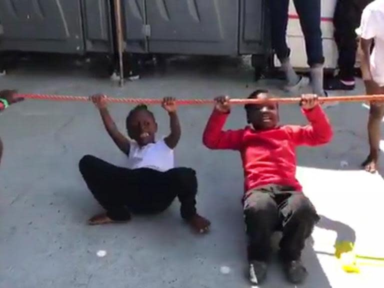 Children laugh and play aboard refugee boat headed for Spain