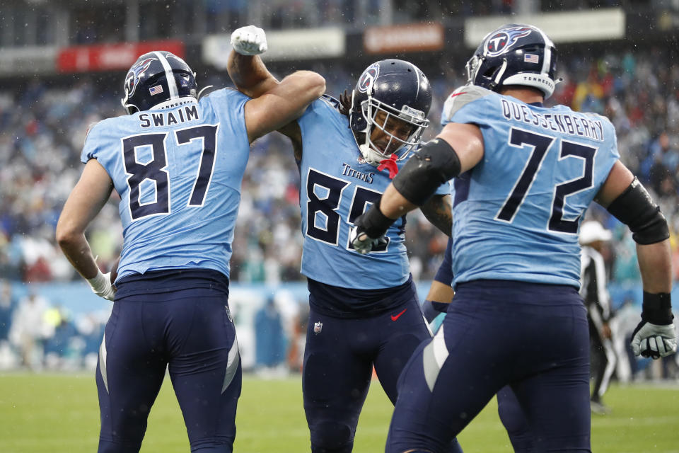 Tennessee Titans tight end Geoff Swaim (87) celebrates with MyCole Pruitt (85) after Swaim caught a touchdown pass against the Miami Dolphins in the first half of an NFL football game Sunday, Jan. 2, 2022, in Nashville, Tenn. (AP Photo/Wade Payne)