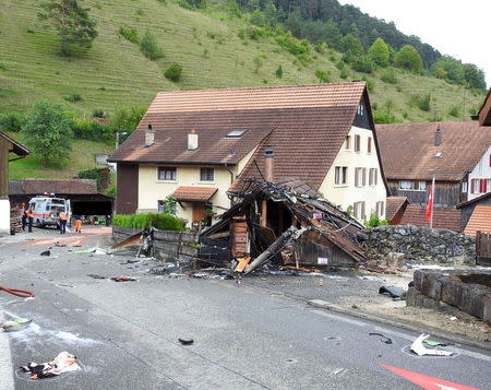 Parts of one of the two planes which crashed during an air show are seen in the village of Dittingen, Switzerland, in this handout photo provided by Kantonspolizei Basel Landschaft on August 23, 2015. REUTERS/Kantonspolizei Basel Landschaft/Handout via Reuters