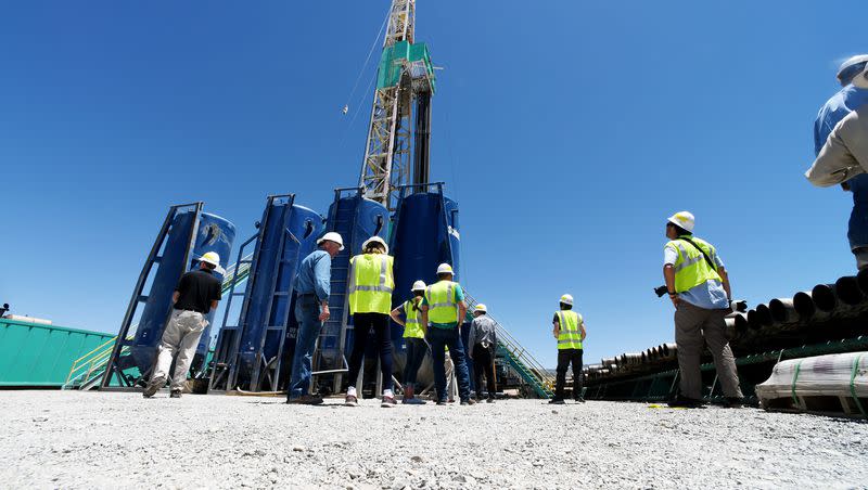 A group of media watch crew men work during a tour of a drilling rig at the FORGE geothermal demonstration site near Milford on July 6, 2023.