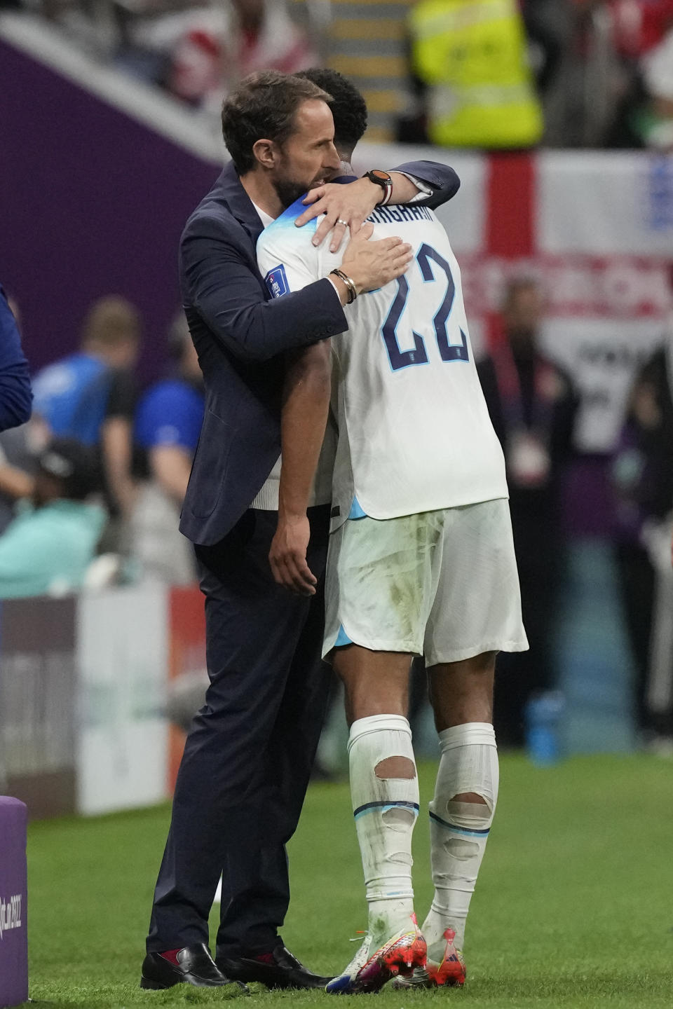 England's head coach Gareth Southgate embraces Jude Bellingham after replacing him for Mason Mount during the World Cup round of 16 soccer match between England and Senegal, at the Al Bayt Stadium in Al Khor, Qatar, Sunday, Dec. 4, 2022. (AP Photo/Frank Augstein)