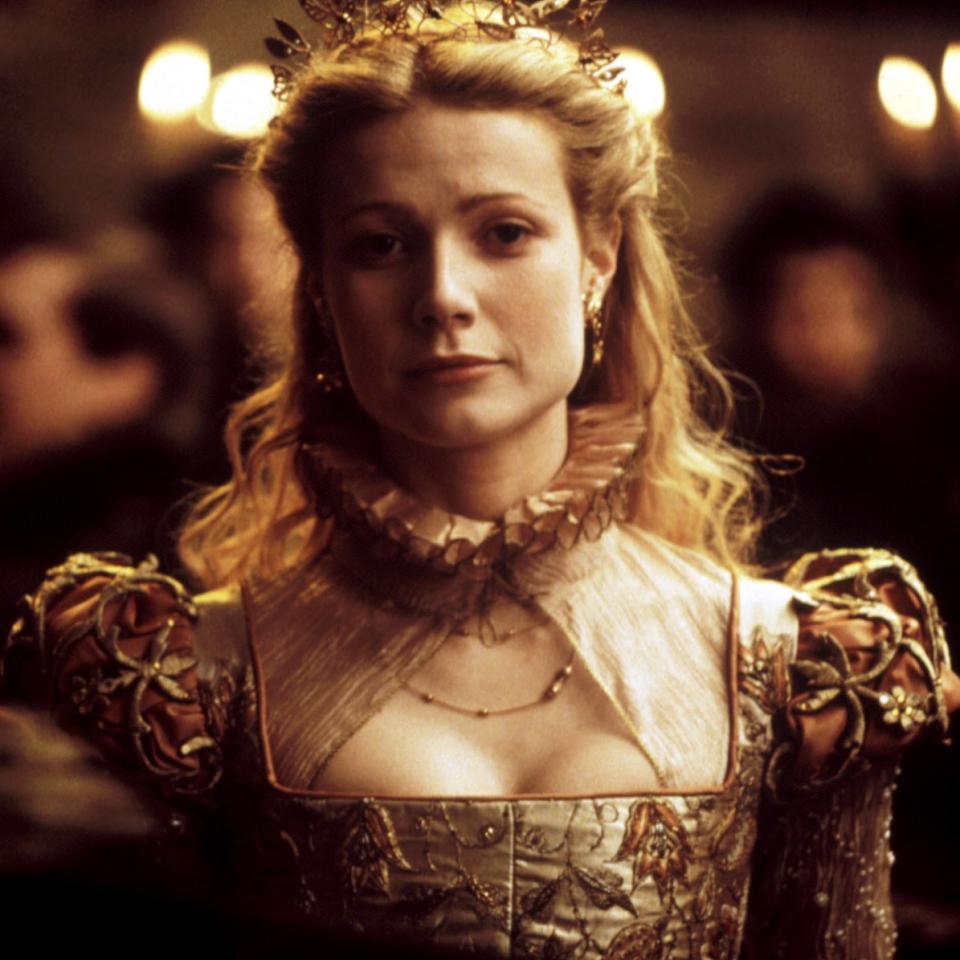 Gwyneth in a historical drama film wearing an elaborate gold gown with decorative neckline