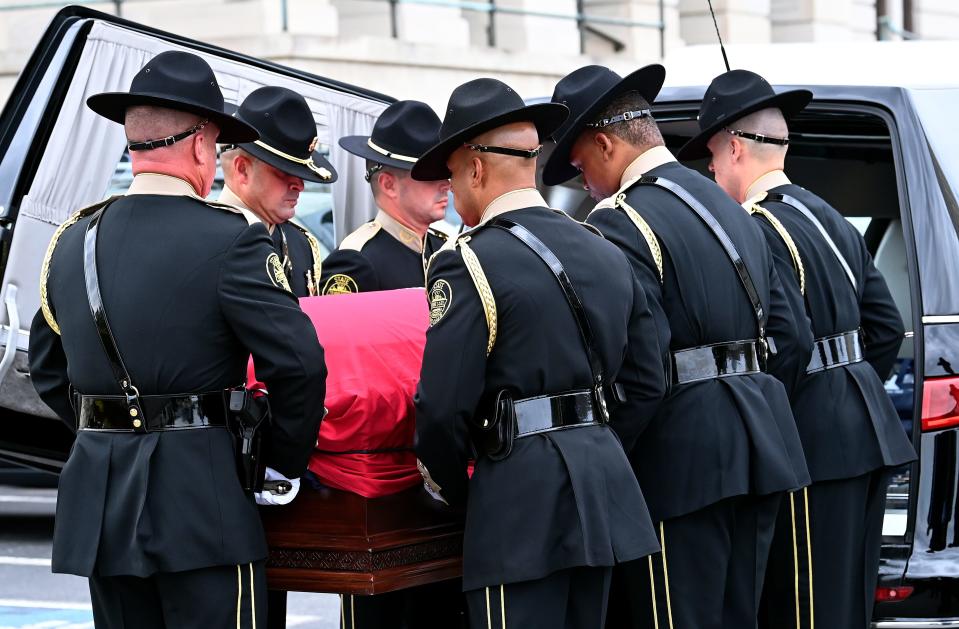 Tennessee State Trooper Honor Guard remove the casket carrying Republican Gov. Don Sundquist from the hearse before lying in state at the State Capitol rotunda Tuesday, Sept. 5, 2023, in Nashville, Tenn.