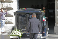 A hearse carrying ashes of Mexican singer Jose Jose arrives to the Palace of Fine Arts in Mexico City, Wednesday, Oct 9, 2019. Jose Jose died Sept. 28 in South Florida. His body was cremated in Miami, and it was agreed after a dispute among relatives over his remains, that half the ashes would remain there and the other half would be brought to Mexico. (AP Photo/Ginnette Riquelme)