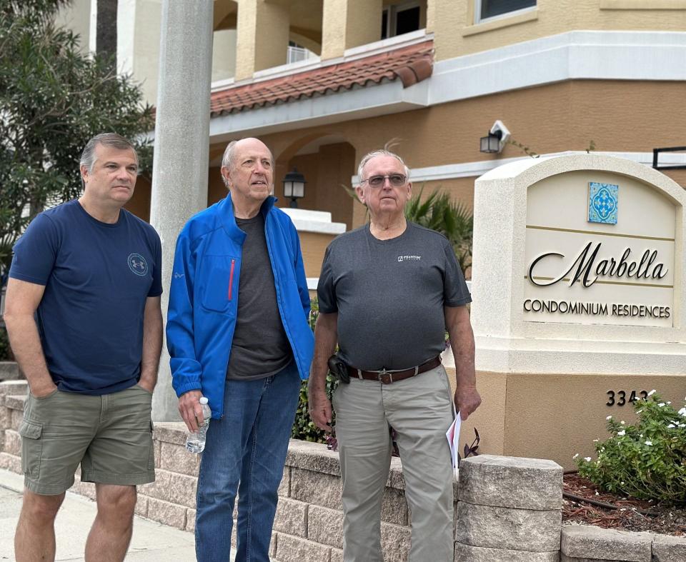 From left, Rob Lasch, Jim Smith and Tom Baker, board members of the Marbella Condominiums Association board, pose outside their building in Daytona Beach Shores, where their building insurance fee in 2022 of just over $40,000 jumped to more than $269,000 this year.