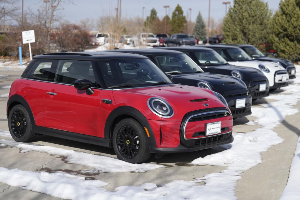 Unsold 2024 Cooper SE electric hardtops sit outside a Mini dealership on Thursday, Nov. 30, 2023, in Loveland, Colo. EV inventory is building on dealer lots, and many EV models are taking longer to sell than gas counterparts. (AP Photo/David Zalubowski)