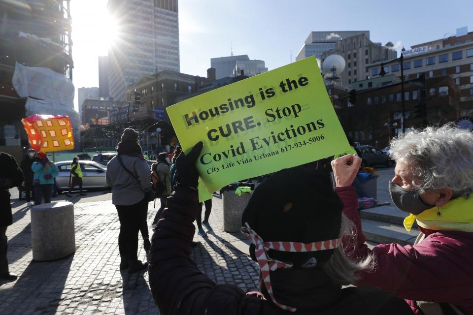 FILE - In this Jan. 13, 2021 file photo, tenants' rights advocates demonstrate outside the Edward W. Brooke Courthouse in Boston. States have begun to ramp up the amount of rental assistance reaching tenants but there are still millions of families facing eviction who haven't gotten help. The Treasury Department says just $5.1 billion of the estimated $46.5 billion in federal rental assistance, or only 11%, has been distributed by states and localities through July. (AP Photo/Michael Dwyer, file)