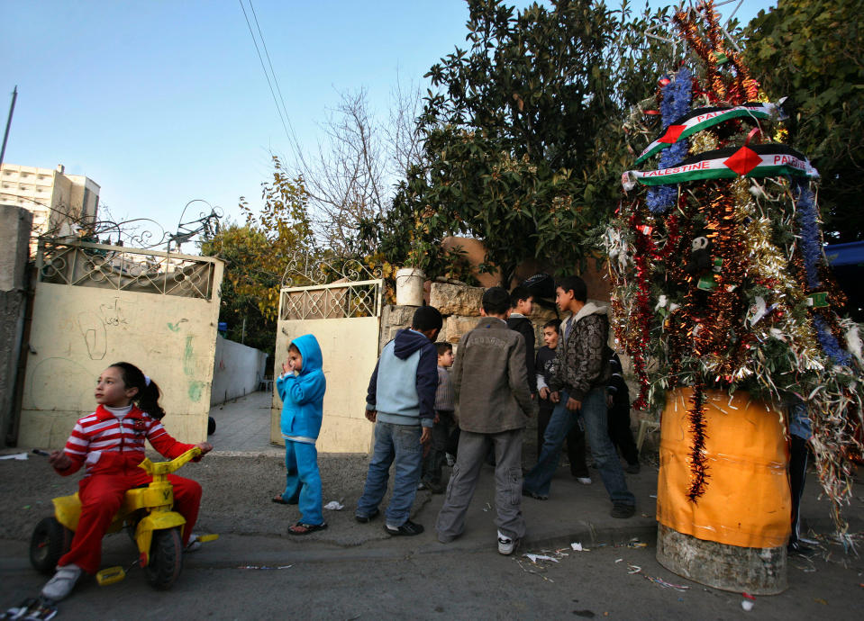 Palestinian children gather around a Christmas Tree during a ceremony in the East Jerusalem neighborhood of Sheikh Jarrah on Dec. 23, 2009.<span class="copyright">Dan Balilty—AP</span>