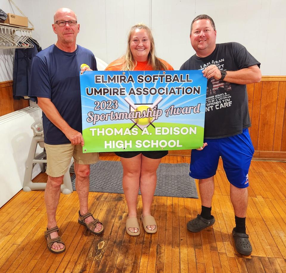 Tom Lewis, president of the Elmira Softball Umpires Association, presents the group's High School Softball Team Program Sportsmanship Award for the 2023 season to Thomas A. Edison varsity coach Liz Warren and JV coach Don Wainwright.