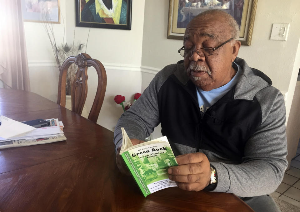In this Jan. 31, 2019 photo, Charles Becknell, Sr., 77, holds a copy of 1954 the edition of "The Negro Motorist Green Book" at his home in Rio Rancho, N.M. The Oscar-nominated interracial road trip movie "Green Book" has spurred interest in the 20th Century guidebook that helped black travelers navigate segregated America. (AP Photo/Russell Contreras)