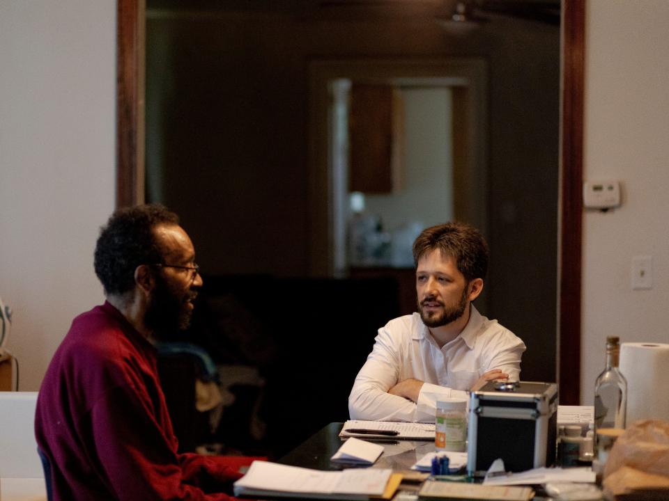 William Kelly and his lawyer sitting in a table discussing his case.