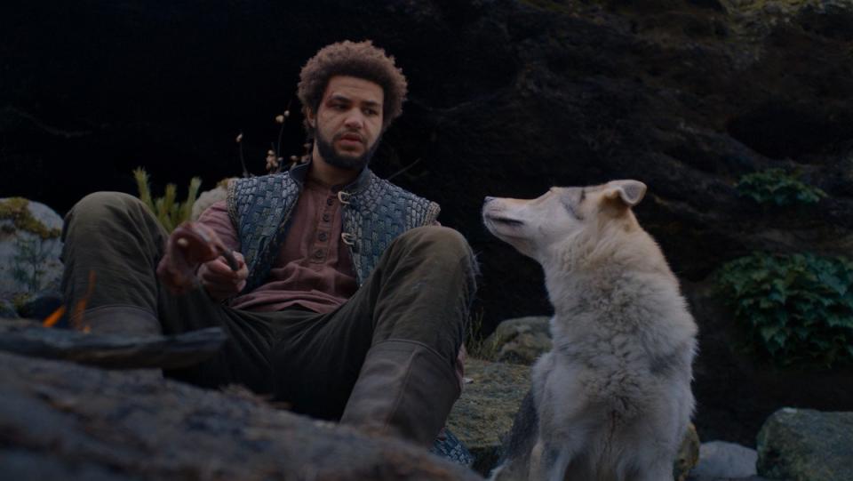 Perrin sitting with Hopper the wolf in The Wheel of Time