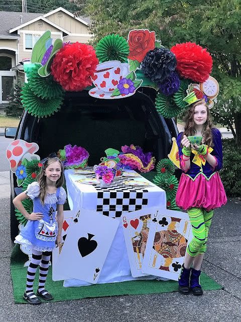 <p>You're invited to a tea party — a mad tea party. This <em>Alice in Wonderland</em>-themed trunk-or-treat is set out for tea with a checkerboard table runner and oversized playing cards.</p><p><a href="http://www.alovelydesign.com/2017/10/trunk-or-treat.html" rel="nofollow noopener" target="_blank" data-ylk="slk:See more at A Lovely Design »;elm:context_link;itc:0;sec:content-canvas" class="link "><em>See more at A Lovely Design »</em></a></p>