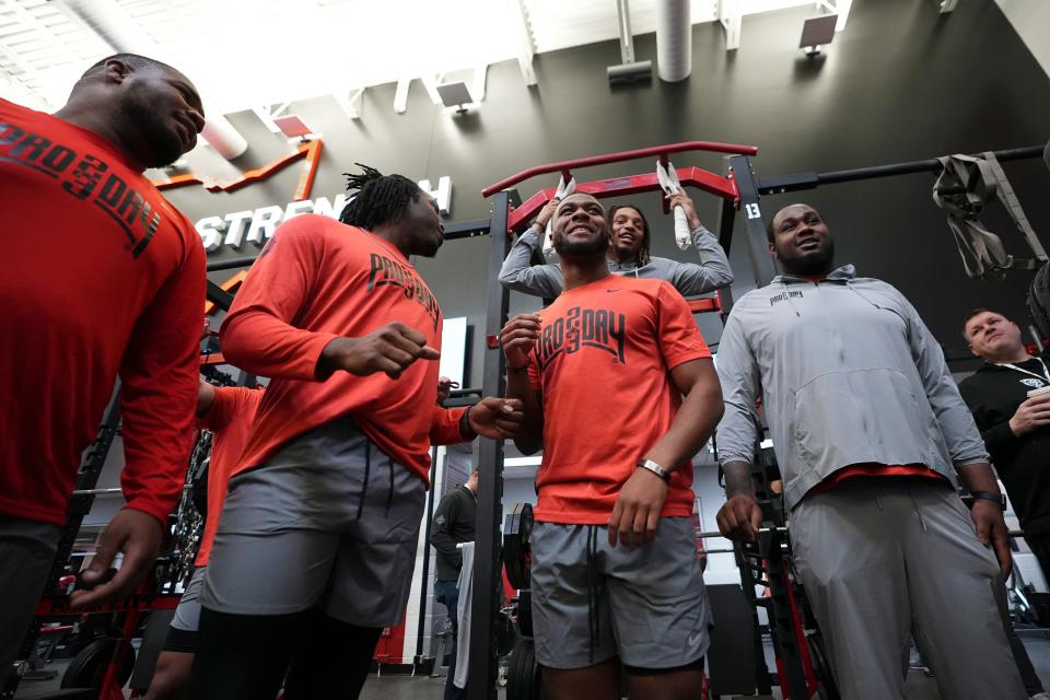 From left, Ohio State Buckeyes defensive tackle Jerron Cage, defensive end Zach Harrison, cornerback Cam Brown, safety Ronnie Hickman (rear) and offensive tackle Dawand Jones participate in Ohio State football’s pro day at the Woody Hayes Athletic Center in Columbus on March 22, 2023. 