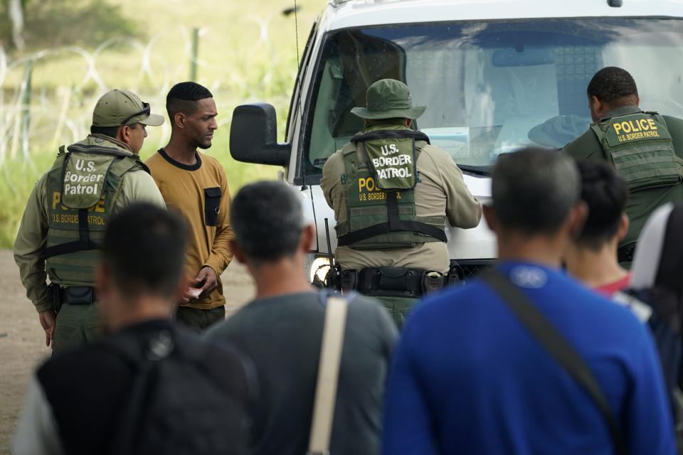 Migrants are processed by the Border Patrol after illegally crossing the Rio Grande river from Mexico into the U.S. at Eagle Pass, Texas, Friday, Aug. 26, 2022. The area has become entangled in a turf war between the Biden administration and Texas Gov. Greg Abbott over how to police the U.S. border with Mexico. (AP Photo/Eric Gay)