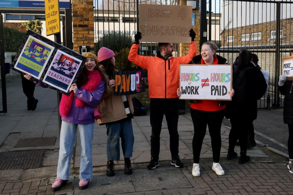 Teachers join the strike action at a picket line at The Hurlingham Academy in Fulham (REUTERS)