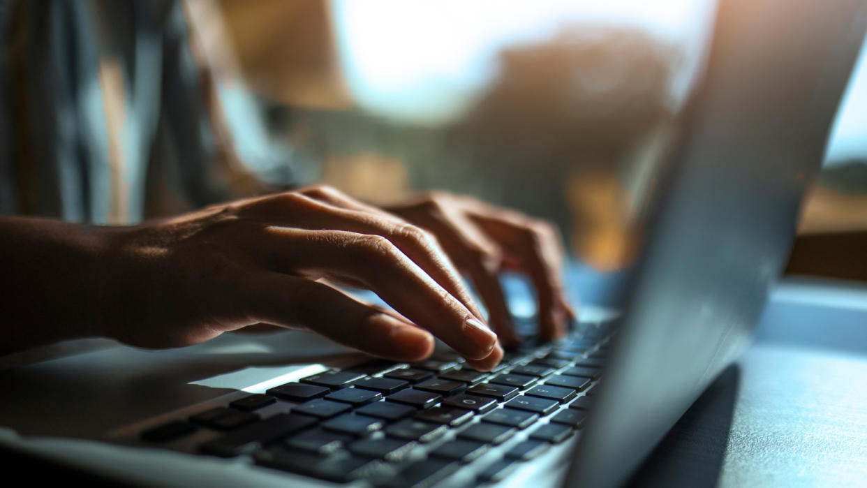  Close up of a hands on a laptop keyboard. 