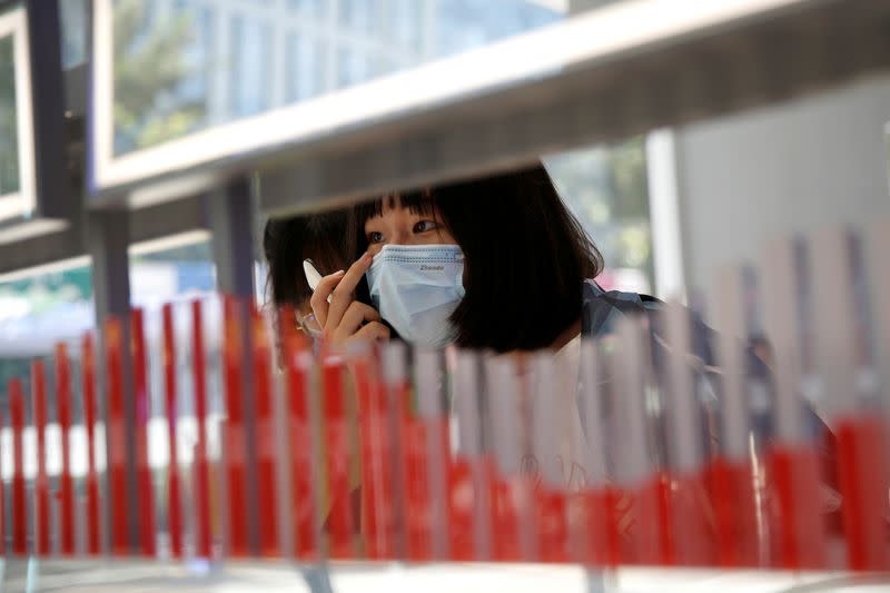 A customer wearing a face mask tries on makeup products at a Chinese cosmetics brand Perfect Diary store, following the coronavirus disease (COVID-19) outbreak in Beijing