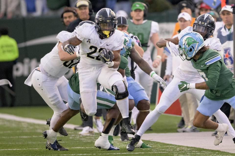 UCF running back RJ Harvey runs against Tulane during the second half of an NCAA college football game in New Orleans, Saturday, Nov. 12, 2022. (AP Photo/Matthew Hinton)