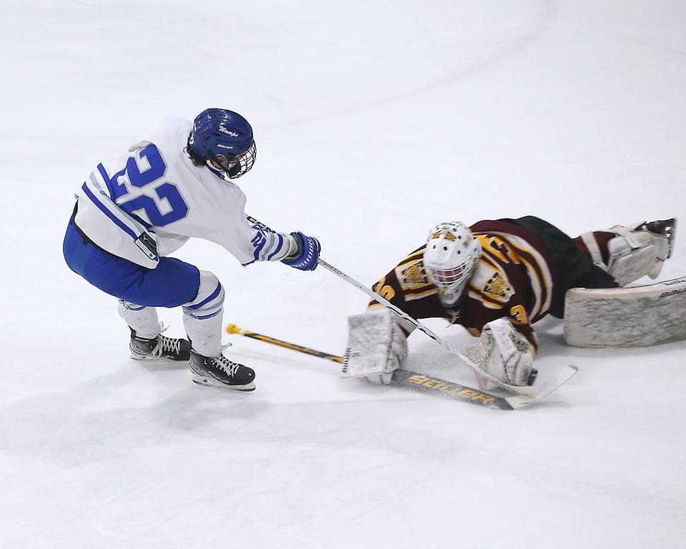 Weymouth goalie Grady Salfity dives out to prevent the scoring opportunity by Braintree's Kyle Hutchinson during first period action of their game in the Round of 32 game in the Division 1 state tournament at Zapustas Ice Arena in Randolph on Wednesday, March 1, 2023.
