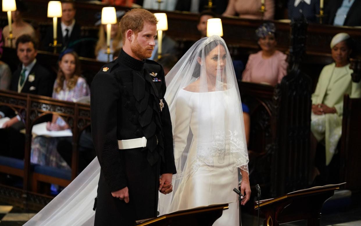 Prince Harry walked down the aisle on his wedding day with his beard and wearing his military uniform - Dominic Lipinski/PA