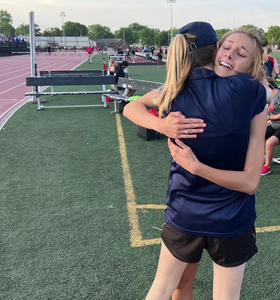 Harrison senior Jaylie Lohmeyer gets congratulated by coach Creasy Huntsman after breaking the Lafayette Jeff Regional record in the 400 meters.