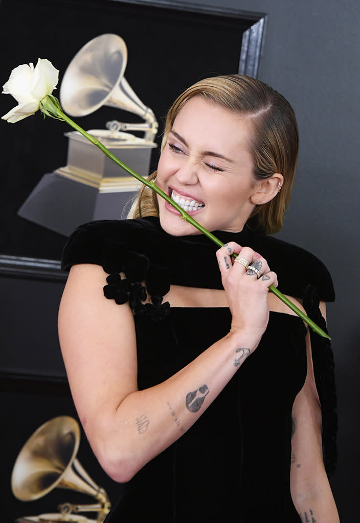 <p><em>The Voice</em> judge posed with a white rose Sunday on the Grammys red carpet. Celebs carried the flower as a symbol of support for the #TimesUp movement. Cyrus later performed <a rel="nofollow" href="https://www.yahoo.com/entertainment/unlikely-friends-miley-cyrus-elton-john-gush-grammys-performance-211508363.html" data-ylk="slk:an amazing duet;elm:context_link;itc:0;sec:content-canvas;outcm:mb_qualified_link;_E:mb_qualified_link;ct:story;" class="link  yahoo-link">an amazing duet</a> with Sir Elton John. (Photo: Steve Granitz/WireImage) </p>